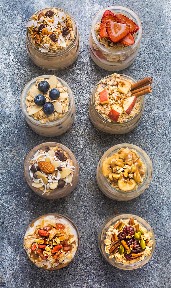 Eight Mason Jars Filled with Each Overnight Oatmeal Variation on a Granite Countertop