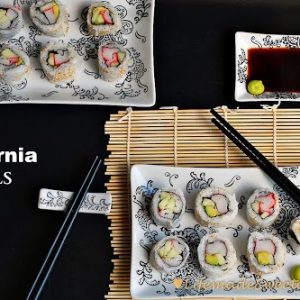 California Rolls on rectangular plates with chopsticks and a small dish of soy sauce