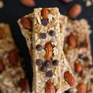 A Stack of Coconut Almond Granola Bars on a Black Surface