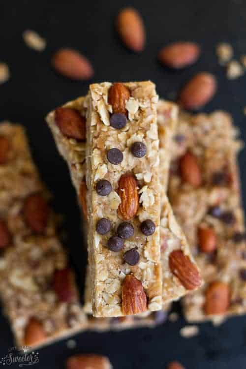 Overhead view of a stack of granola bars, covered in almonds and chocolate chips