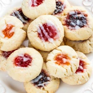 Shortbread thumbprint cookies with a variety of jelly fillings on a plate
