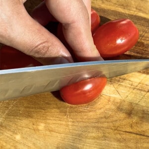 Close-up of grape tomatoes being halved