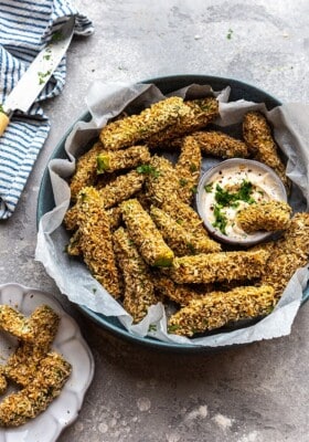 Top view of crispy avocado fries in a bowl with dip