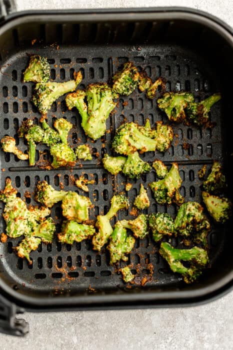 Top view of air fried broccoli in the air fryer basket