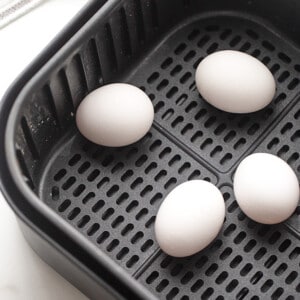 Four Large, White Eggs in the Basket of an Air Fryer