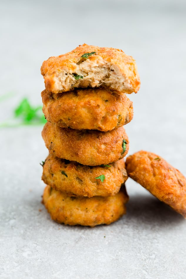 One stack of air fryer salmon patties with fresh parsley.