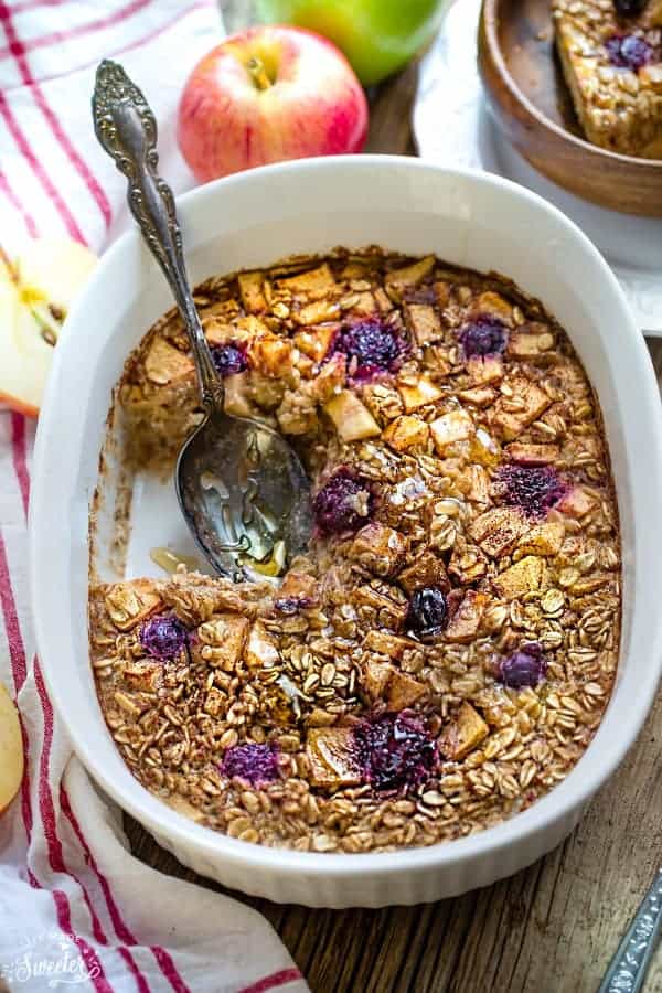 apple cinnamon baked oatmeal in a casserole dish with spoon for serving