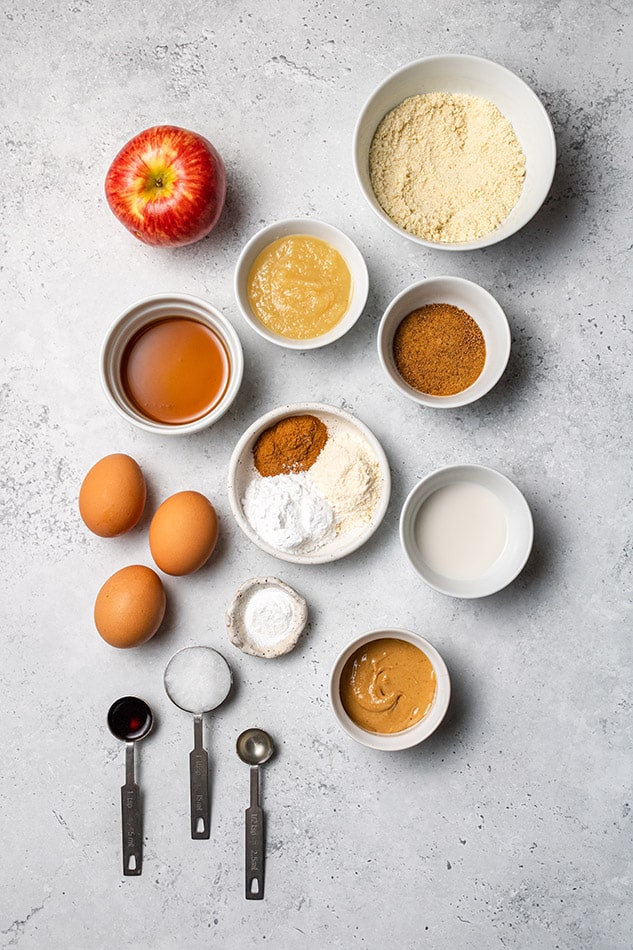 Overhead view of ingredients for apple pancakes in individual bowls