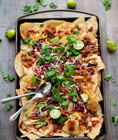 Asian Chicken Nachos - a simple and flavorful appetizer perfect for parties, game day or any meal you want. Best of all, easy to make ahead in the slow cooker or the Instant Pot.