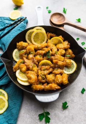Top view of Asian Honey Lemon Chicken in a skillet with lemon slices