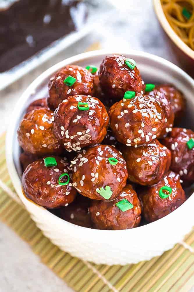 Asian Glazed Meatballs - moist and tender chicken meatballs are the perfect appetizers for game day and any Super Bowl parties. Best of all, they are so full of flavor - baked and coated in a sweet and sticky glaze.