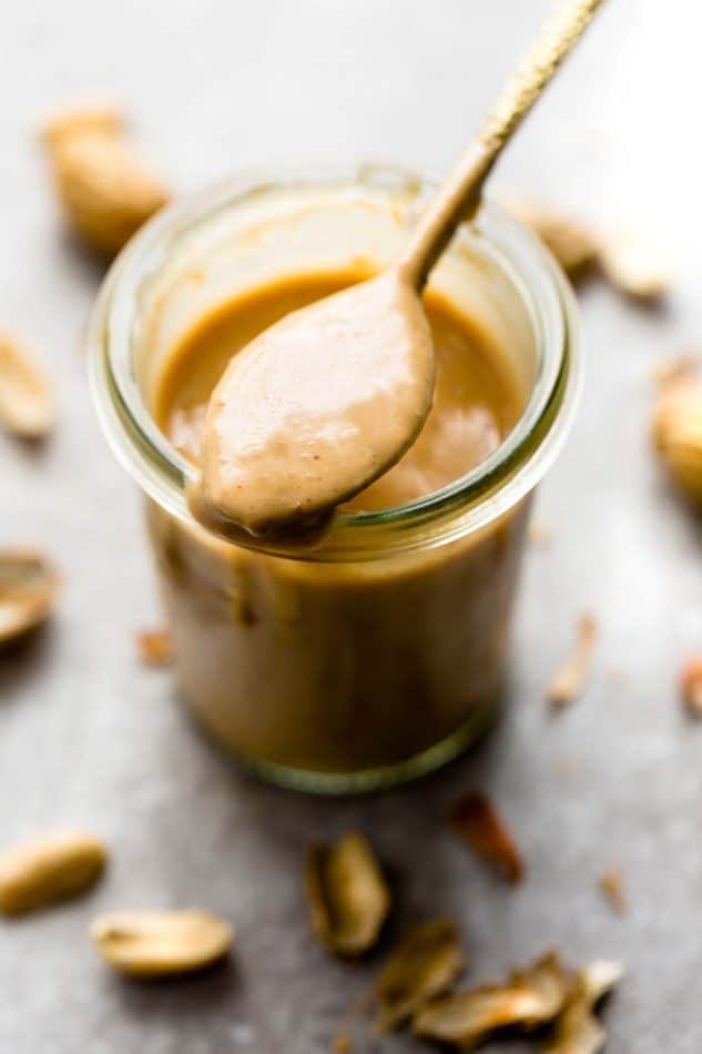 Thai Peanut Dressing in a jar with a spoon