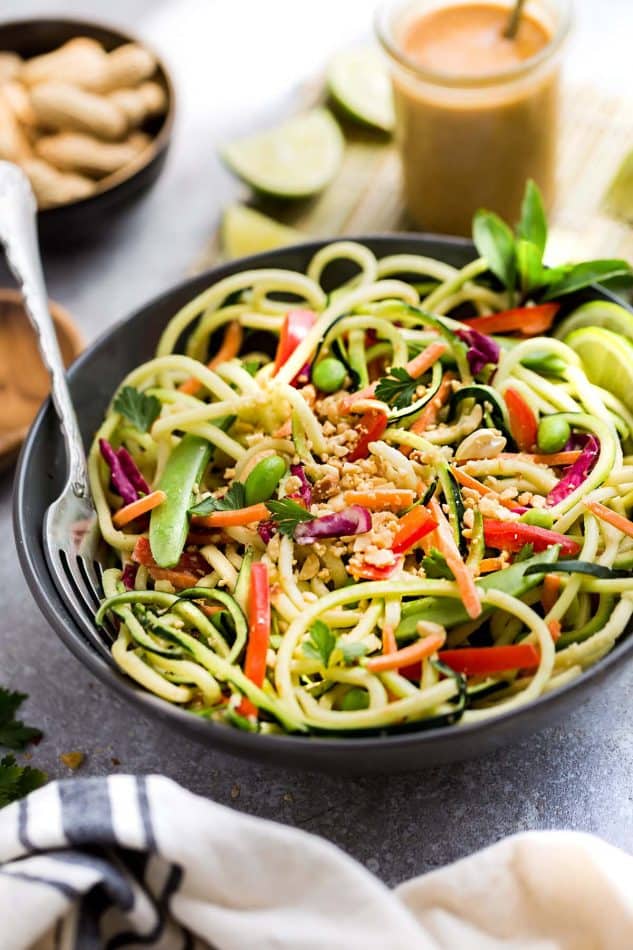 This Asian Zucchini Noodle Salad with Thai Peanut Dressing is the perfect healthy and easy way to use up some summer garden zucchini. Best of all, it's super simple to customize with chicken, shrimp or leave it as is for meatless, vegetarian version. A delicious lunch or light dinner and easy to make ahead for Sunday meal prep for work lunches or lunch bowls.