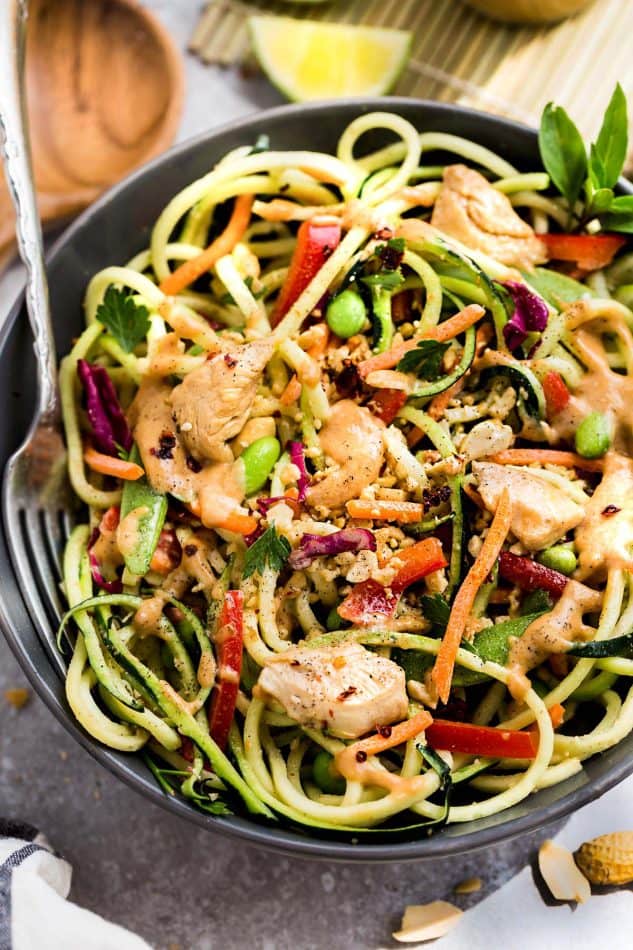 This Asian Zucchini Noodle Salad with Thai Peanut Dressing is the perfect healthy and easy way to use up some summer garden zucchini. Best of all, it's super simple to customize with chicken, shrimp or leave it as is for meatless, vegetarian version. A delicious lunch or light dinner and easy to make ahead for Sunday meal prep for work lunches or lunch bowls.