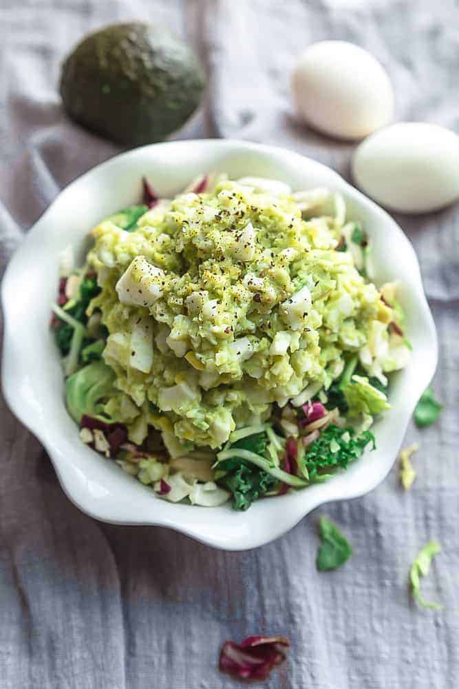 Close up view of keto avocado egg salad in a white bowl for Memorial Day.