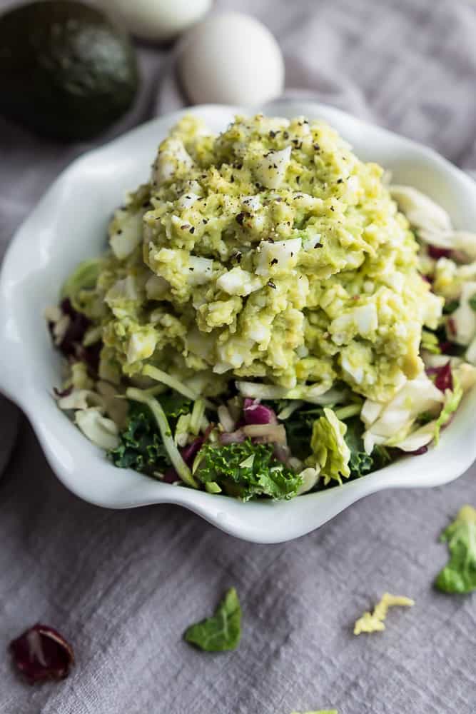 A close-up shot of a small bowl full of keto avocado egg salad