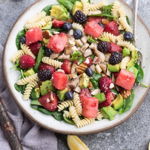 Berry Avocado Spinach Pasta Salad - the perfect summer salad for easy lunches, potlucks, barbecues & parties. Best of all, this recipe comes together quickly with healthy greens, in-season fruit, chopped nuts and crumbled cheese.