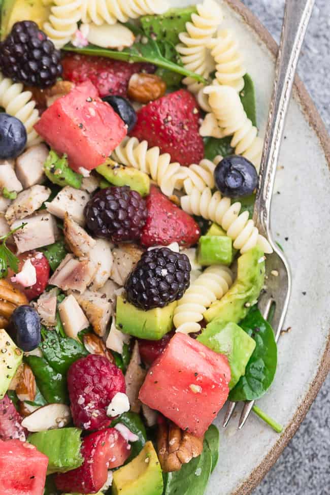 Close-up image of berry avocado pasta salad for Memorial Day.