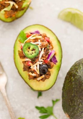Taco Stuffed Avocado Cups – a fun appetizer based on the classic Mexican favorite and perfect for parties. Best of all, this recipe is gluten free, keto and low-carb friendly.