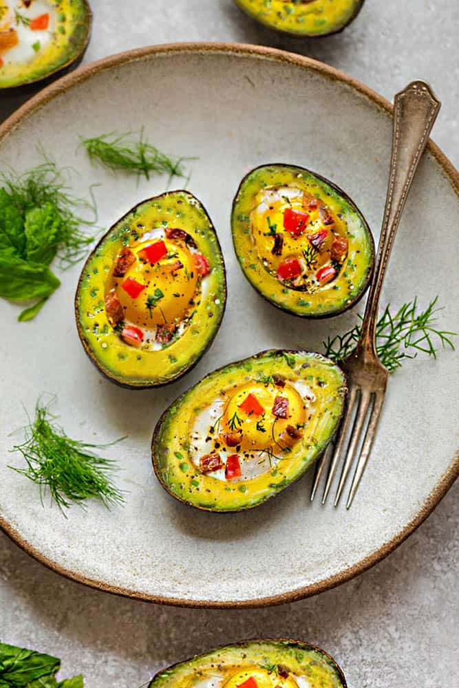 Avocado Egg Cups baked with crispy bacon and bell pepper are a super healthy and easy breakfast to start the day. Best of all, this simple recipe comes together in less than 30 minutes. Low carb, keto and paleo friendly.
