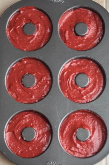 Baked Red Velvet Cake Donut batter in a donut pan