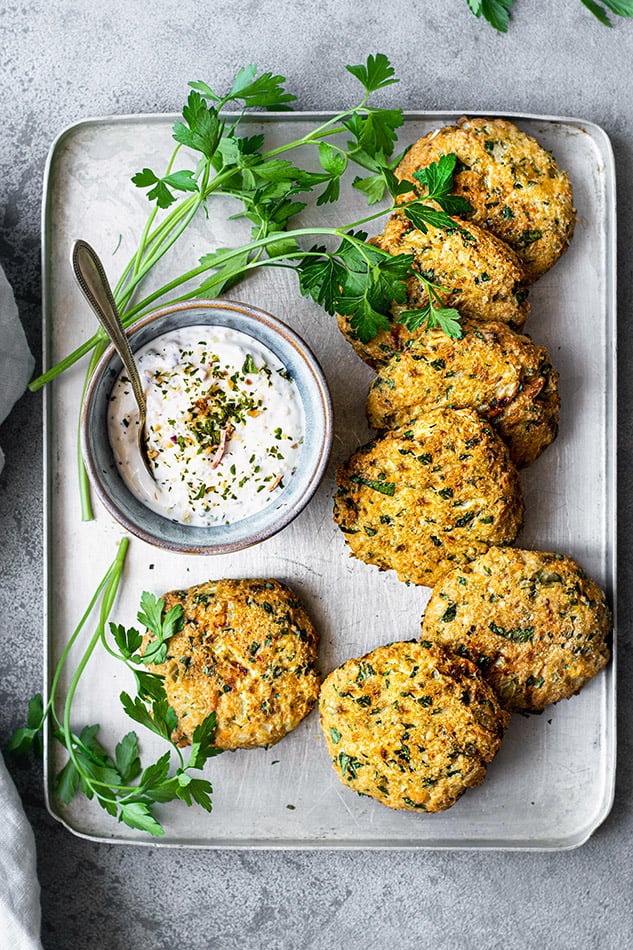 Overhead image of salmon cakes on tray with parsley.