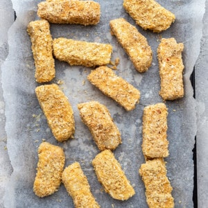 Unbaked tofu fries on a baking sheet lined with parchment paper