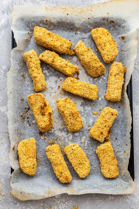 Crispy tofu cutlets on a baking sheet lined with parchment paper
