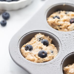 Close-up view of blueberry muffin batter in muffin pan