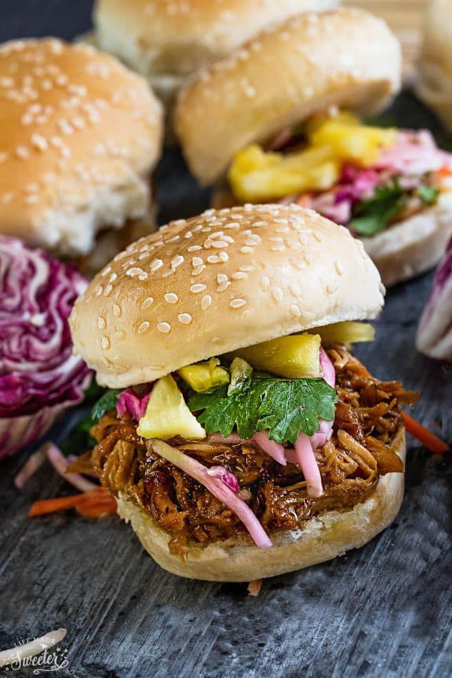 Balsamic Honey Pulled Pork Sliders make the perfect easy dinner or game day party appetizers! Best of all, the soft and tender pork comes together easily in the slow cooker so you can still watch the football game while these cook up!