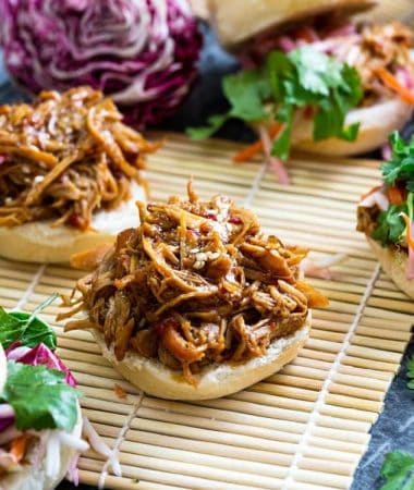 Balsamic Honey Pulled Pork Sliders make the perfect easy dinner or game day party appetizers! Best of all, the soft and tender pork comes together easily in the slow cooker so you can still watch the football game while these cook up!