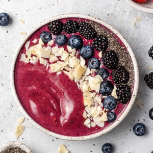Top shot of one berry açai smoothie in a white bowl
