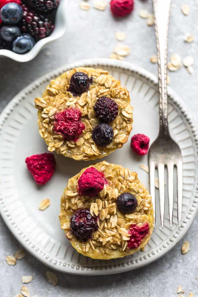 two berry baked oatmeal muffins on a plate