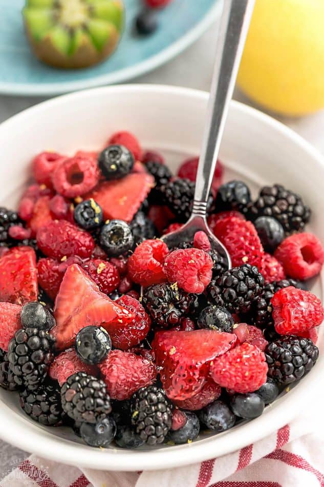 Mixed Berry Fruit Salad – a healthy snack or dessert with a refreshing lemon and honey glaze. Best of all, so easy to customize with your favorite fresh fruit. An easy red, white and blue dish that's perfect to bring along to Memorial Day, Fourth of July potluck, summer barbecue, party or picnic. A delicious snack for kids and adults!