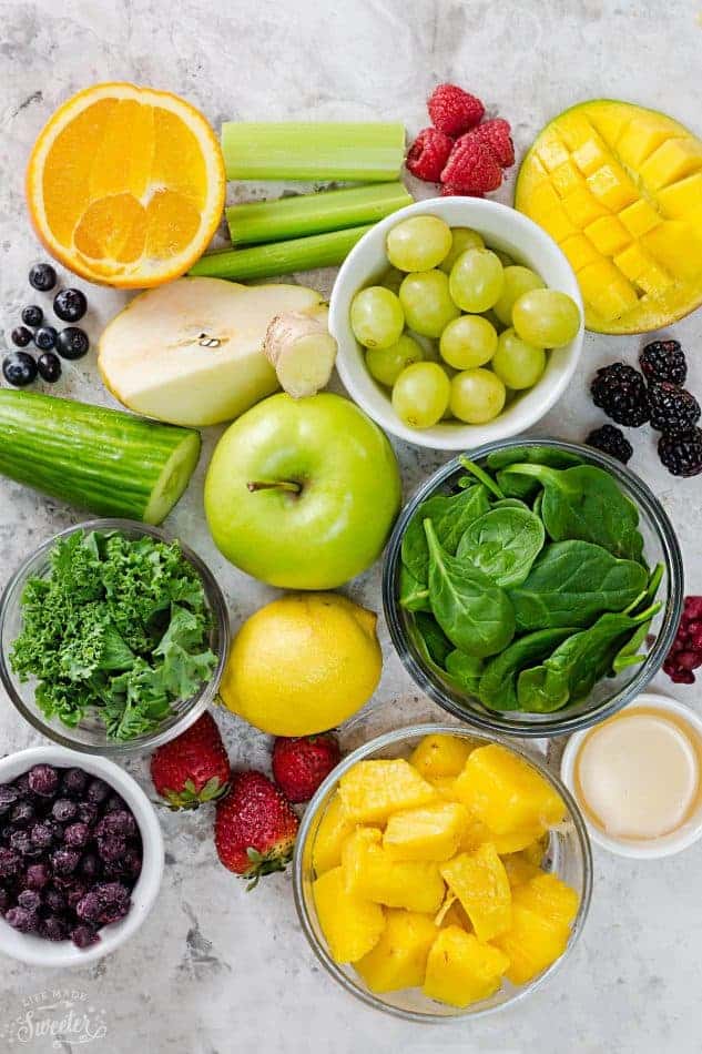 Top view of ingredients to make a green smoothie on a grey background