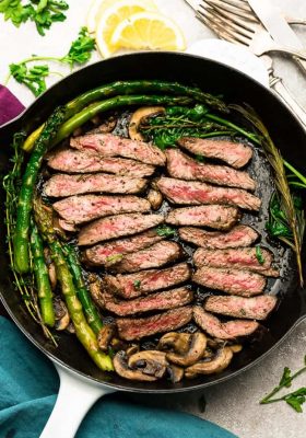 Garlic Steak with Herb Butter, Asparagus and Mushrooms - pan seared in a skillet plus "how to" tips to cook the best tender steak at home. This easy to customize recipe is also gluten free, low carb, paleo and keto friendly.