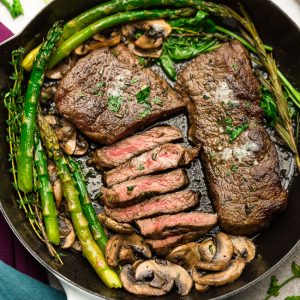 ﻿﻿﻿Garlic Steak with Herb Butter, Asparagus and Mushrooms - pan seared in a skillet plus "how to" tips to cook the best tender steak at home. This easy to customize recipe is also gluten free, low carb, paleo and keto friendly.