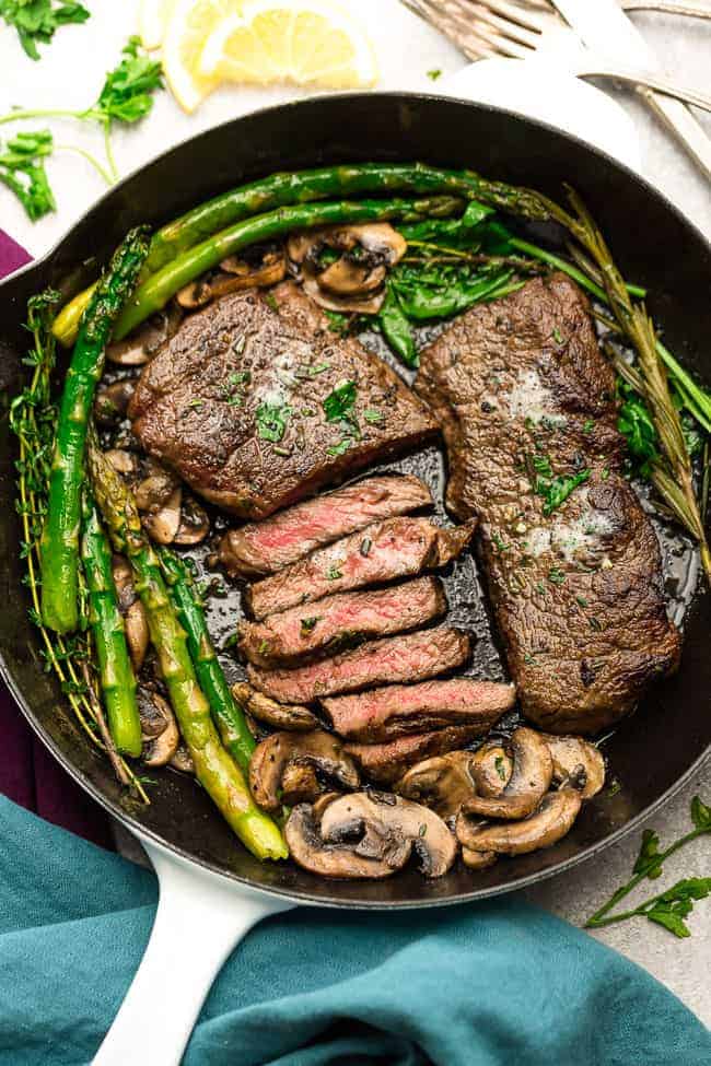 Garlic Steak with Herb Butter, Asparagus and Mushrooms - pan seared in a skillet plus "how to" tips to cook the best tender steak at home. This easy to customize recipe is also gluten free, low carb, paleo and keto friendly.