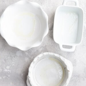 Three White Baking Dishes on a Gray Marble Countertop