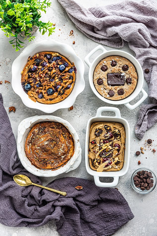 Blueberry Muffin Oatmeal, Churro Oatmeal, PB&J Oatmeal and Grain-Free Oatmeal on a Table with Two Cloths