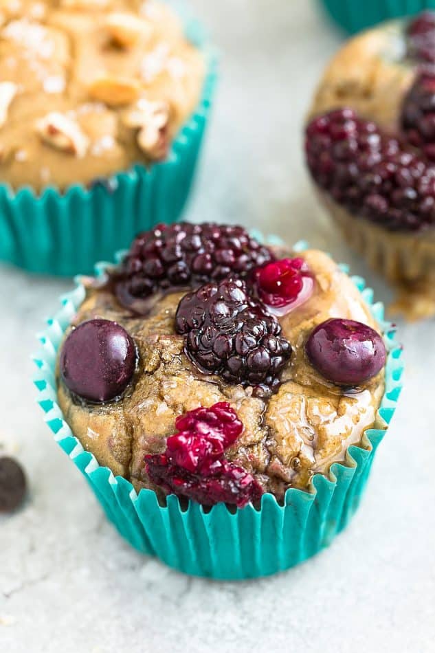 Close-up of an Easy Blender Muffin with berries in a teal paper muffin cup