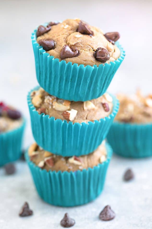 A stack of Easy Blender Muffins with chocolate chips and nuts in teal paper muffin cups