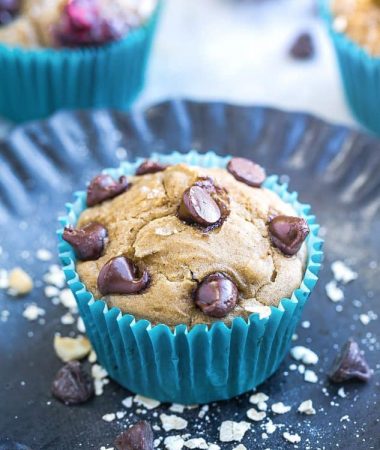 Close-up view of an Easy Blender Muffin with chocolate chips in a teal paper muffin cup