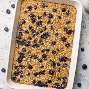 A large casserole dish full of baked oatmeal with blueberries