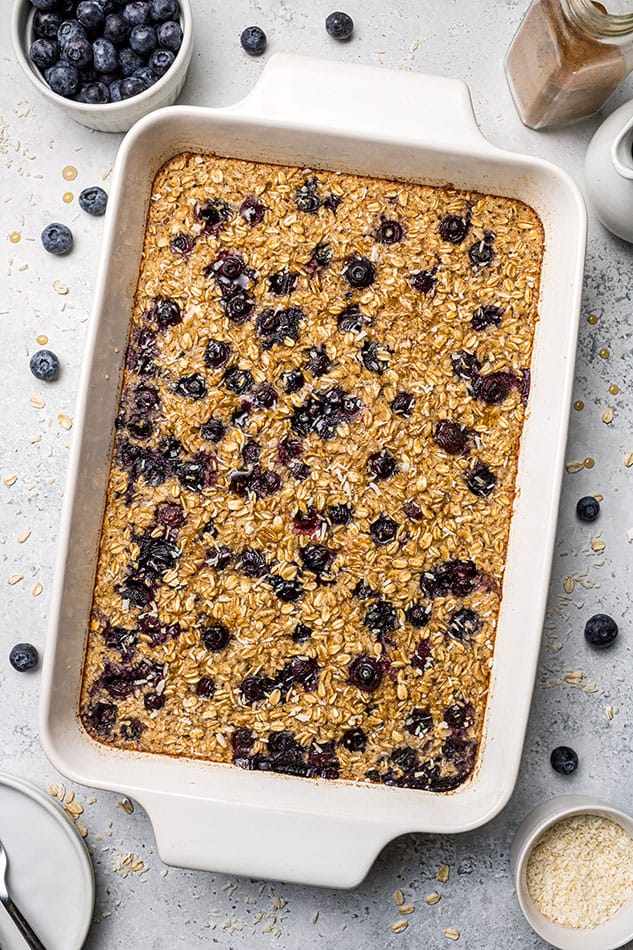A large casserole dish full of baked oatmeal with blueberries