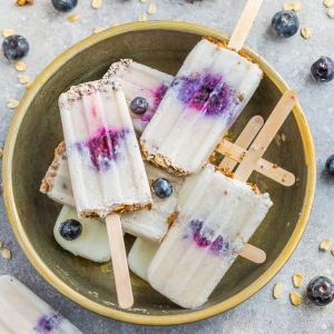 Blueberry Crumble Popsicles make the perfect easy frozen treat. Best of all, it's a healthy, vegan and refined sugar free breakfast or treat for summer. Made with coconut cream, blueberries, maple syrup and an granola oatmeal crumble. Simple and delicious.