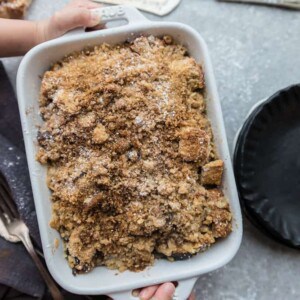 Hands holding a streusel French toast casserole