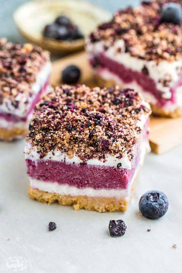 Close-up of a layered Blueberry Frozen Yogurt Bar with cookie crust and crumbly shortbread topping