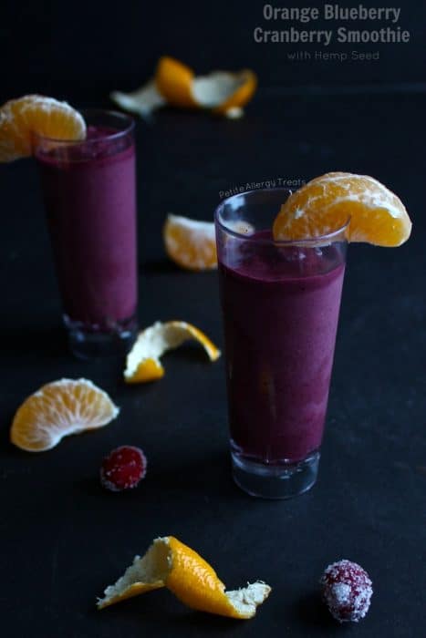 Blueberry Orange Cranberry Smoothie in a glass with orange segments