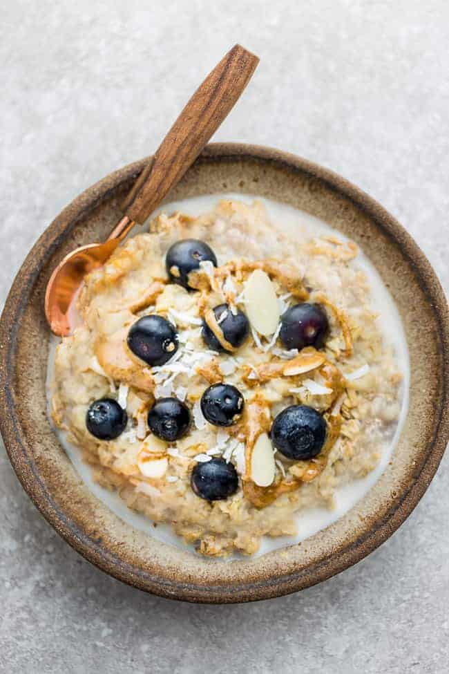 Top view of Blueberry Steel Cut Oats in a ceramic bowl with a spoon